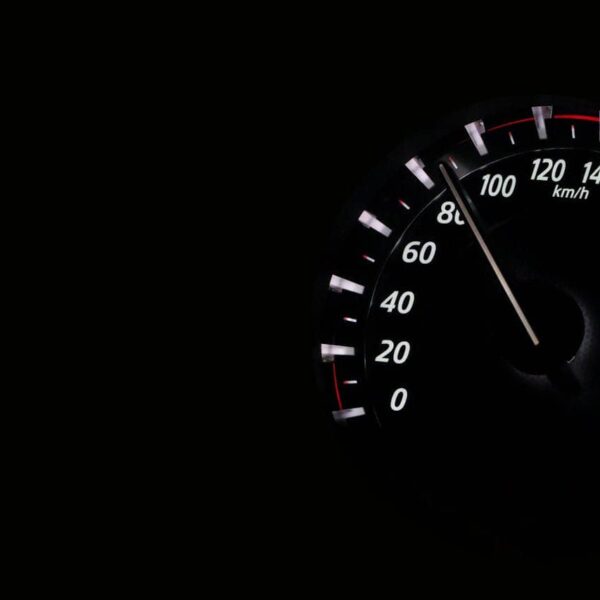 Young driver smiling in their first car, enjoying the freedom of their first journey with insurance