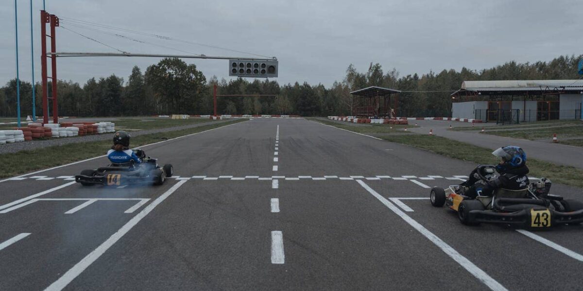 Person karting on a track, wearing racing gear