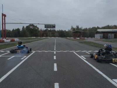 Person karting on a track, wearing racing gear