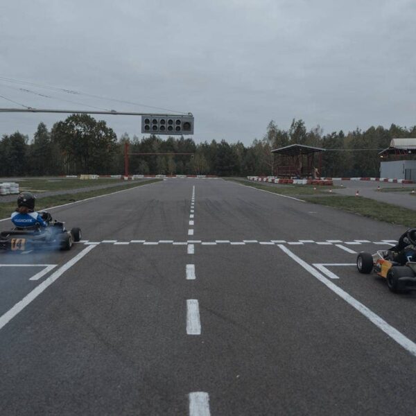 Person karting on a track, wearing racing gear