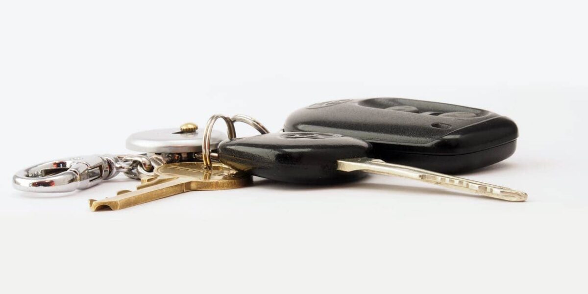A misplaced car key lying on a hallway table near a door hook, illustrating stress-free solutions for lost car keys