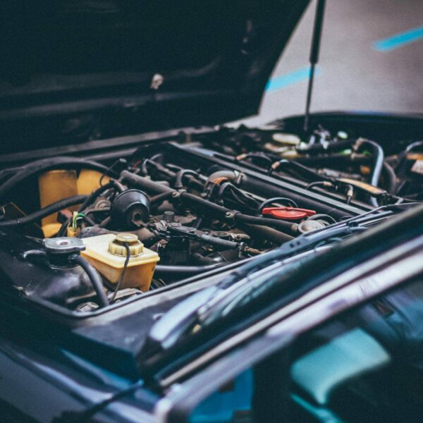 Car parts on a workbench with a mechanic in the background